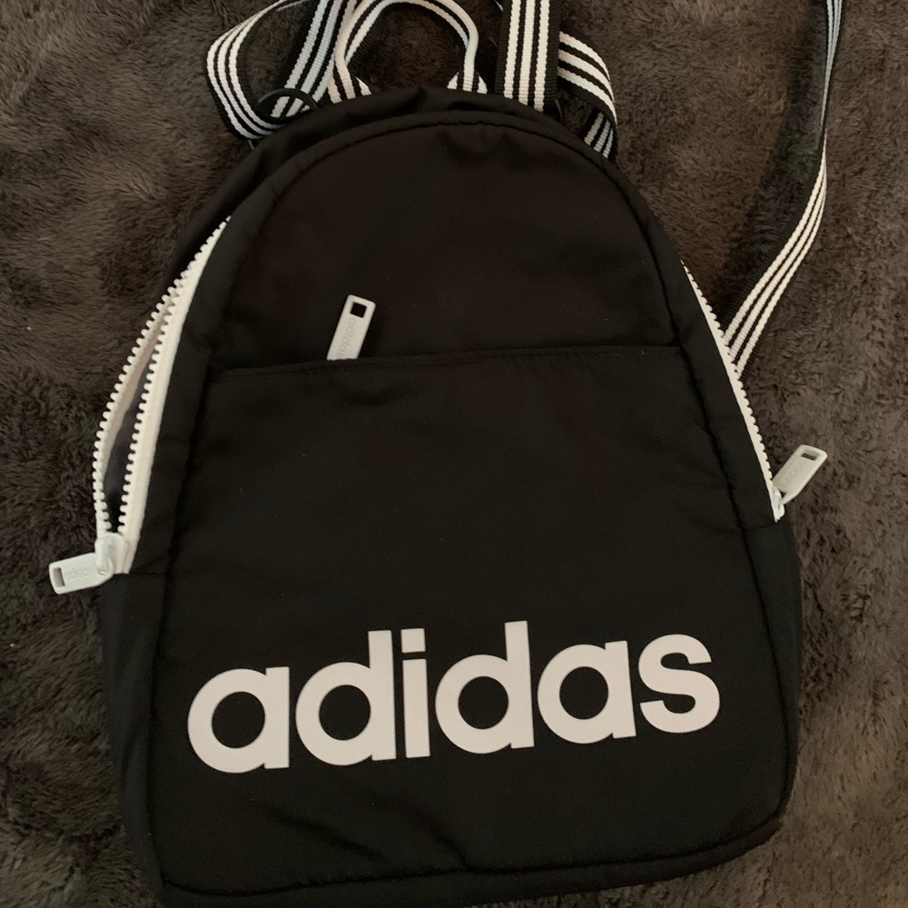 Never used Adidas small backpack.  Perfect for keys, wallet, phone, etc.